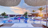 outdoor pool, sitting area, and sunbeds